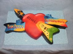 there is a cake shaped like a guitar and some words on the back of it