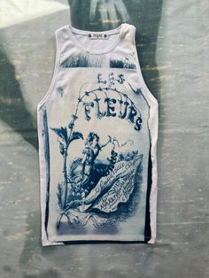 a white tank top with a blue drawing on it