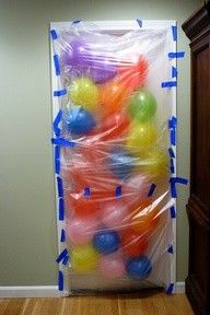 a plastic bag filled with balls sitting on top of a wooden floor