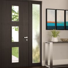 a modern entryway with an art piece and potted plant