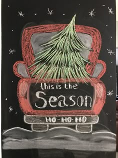 this is the season chalk drawing on a blackboard with red truck and pine tree