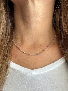 Our favorite layering chain necklace is the Delilah Beaded Satellite chain.    This delicate Stainless Steel or 14K Gold Plated Stainless Steel chain necklace sits close to the neck and features tiny 2mm beads every 2cm.    Wear it on its own for a simple and chic look or pair it with your other favorite necklaces for the ultimate layered look.   Bring instant dimension and flair to your stack with the Delilah Beaded Satellite chain.  Safe for sensitive skin & shower safe. ITEM DESCRIPTION ❤ Choker Necklace ❤ Color:  available in Silver or 14K Yellow Gold ❤ Length: 15 in + 2 in extender ❤ Material: Stainless Steel or 14K Gold Plated Stainless Steel ❤ Sold Individually  ❤ Free Shipping  P R O M O T I O N ✦ 20% Discount is applied for purchases of 2 or more products. Coupon Code: 20FORYOU ✦ Trendy Necklaces With Beaded Chain For Layering, Beaded Chain Necklace For Everyday, Beaded Chain Necklace As A Gift, Everyday Chain Necklace With Round Beads, Everyday Long Beaded Chain Necklace, Trendy Double Strand Beaded Chain Necklace, Double Strand Beaded Necklaces For Layering, Trendy Double Strand Beaded Necklace, Double Strand Beaded Necklace For Layering