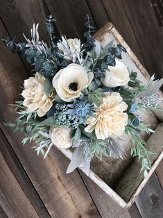 a bouquet of flowers sitting on top of a wooden box