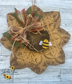 a piece of fabric with a bee on it sitting on top of a wooden table