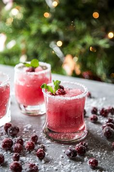 two glasses filled with raspberry margaritas sitting on top of a table