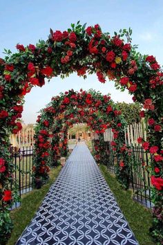 an outdoor ceremony with red flowers and greenery