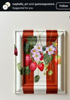 a red and white striped frame with strawberries on it