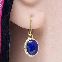 Valued by the Egyptians as a talismanlapis lazuli is still a favorite gem today. These stones are set in a14k gold setting withfiligree edge and feature french hooksfor pierced ears. Size: 3/4 inch. Traditional Gold Jewelry With Oval Cabochon, Gold Lapis Lazuli Jewelry With Cabochon, Yellow Gold Lapis Lazuli Cabochon Jewelry, Gold Lapis Lazuli Cabochon Jewelry, Gold Lapis Lazuli Pierced Jewelry, Gold Oval Lapis Lazuli Jewelry, Gold Lapis Lazuli Jewelry, Traditional Round Lapis Lazuli Jewelry, Oval Gold Lapis Lazuli Jewelry