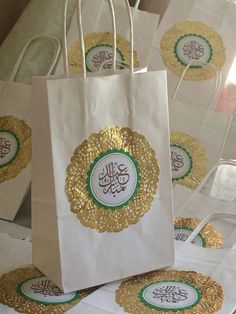 white paper bags with gold foil designs on them