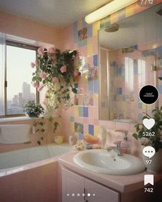 the bathroom is decorated in pastel colors and has pink tiles on the walls, along with a white sink