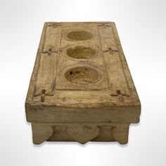 an old wooden box with three holes in the middle and two on each side, sitting against a white background