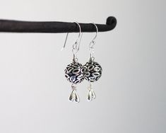 "Oxidized and shiny textured Turkish sterling silver balls are accented with coordinating silver drop charms which dangle from the bottom. Paired with sterling silver ear wires. These earrings are sweet and casual. Perfect for every day wear. Total length from the top of the ear wires to the bottom of the drops measures 1 1/2\". Sterling silver is .925 pure silver. Turkish silver is .925 pure silver. Check out other items in my shop here: https://www.etsy.com/shop/LindseySilberman" Silver Teardrop Earrings With Dangling Beads For Gift, Silver Teardrop Earrings With Dangling Beads, Silver Drop Jewelry With Dangling Charms, Sterling Silver Teardrop Earrings With Dangling Beads For Gifts, Gift Teardrop Earrings With Dangling Beads In Sterling Silver, Sterling Silver Teardrop Earrings With Silver Beads, Silver Sterling Silver Earrings With Dangling Beads, Sterling Silver Teardrop Earrings With Dangling Beads, Gift Sterling Silver Teardrop Earrings With Dangling Beads