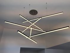 a modern light fixture hanging from the ceiling