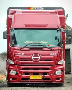 a red truck parked in front of a building