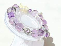 Amethyst Bead: 13mm Wrist Size: 16cm Bracelet can be personalized. Please enter your wrist size for your custom bracelet. Elegant Amethyst Crystal Bracelet With 8mm Beads, Purple Crystal Bracelet With 8mm Beads As A Gift, Lavender Crystal Bracelet With 8mm Beads As Gift, Lavender 8mm Beads Bracelet Gift, Elegant Hypoallergenic Purple Beaded Bracelets, Purple Bracelets With 8mm Beads As Gift, Purple 8mm Beads Bracelets As Gift, Lavender Beaded Bracelets With 8mm Beads For Gift, Amethyst Stretch Bracelet With Round Beads For Gift