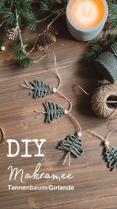 a wooden table topped with christmas decorations and candles next to twine wrapped in twine