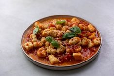 a plate full of pasta and sauce on a table