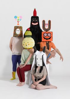 five people in costumes sitting on the floor