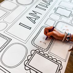 a person's hand writing on a large sheet of paper with the words i am initial letters