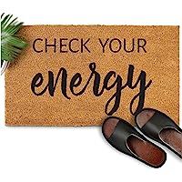 a door mat that says, check your energy with slippers on the floor next to it