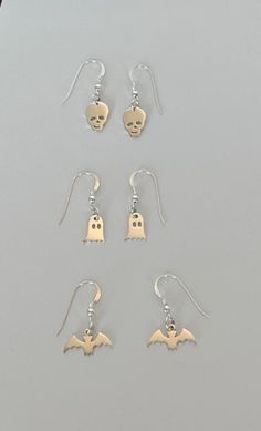 Tiny sterling silver Halloween charm earrings. Choose from the bat, ghost or skull. Sterling ear wires Spooky Silver Dangle Earrings, Whimsical Halloween Dangle Jewelry, Spooky Nickel-free Silver Earrings, Spooky Silver Pierced Earrings, Spooky Silver Nickel-free Earrings, Halloween Sterling Silver Dangle Jewelry, Sterling Silver Dangle Jewelry For Halloween, Spooky Hypoallergenic Jewelry For Halloween, Handmade Sterling Silver Halloween Earrings