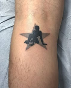 a man with a star tattoo on his leg