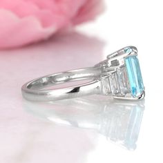 Gorgeous Classic Emerald Cut Aquamarine Ring ►Made of solid sterling silver with rhodium finish (925) ►Average band width: 2.3 mm ►Accented With Simulated Diamonds (CZ) Center Stone: Aquamarine Shape: Emerald Gem size: 7.0 x 9.0 mm Carat Weight: 2.5 ct. (approx.) Gemstone creation: lab-grown Hardness: 8 (Mohs scale) ✓ 100% Nickel-Free ✓ Hypoallergenic ✓ Comfort Fit ✓ Free Ring Box ✓ Free USA Shipping *All listing photos are subject to copyright. *All rights reserved. © 2021 Aquamarise Baguette Cut Ring With Side Stones As Gift, Baguette Cut Rings With Side Stones For Gift, Emerald Cut Aquamarine Ring, Aquamarine Ring Vintage, Emerald Cut Engagement, Emerald Gem, Sterling Silver Rings Set, Aquamarine Engagement Ring, Mohs Scale