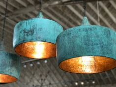 three blue and gold lamps hanging from the ceiling