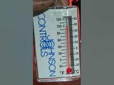 a thermometer that is sitting on top of a table next to a person