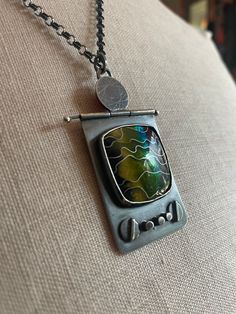 a necklace with an old tv on it