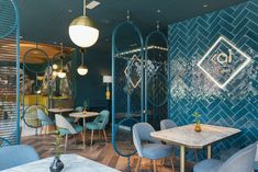 the interior of a restaurant with blue walls and chairs