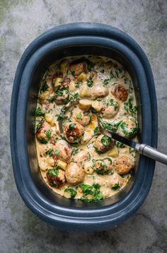 a blue bowl filled with food on top of a table