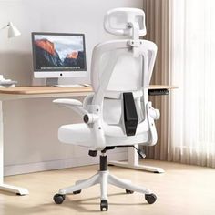 a white office chair sitting in front of a desk with a computer monitor on it