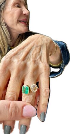 an older woman holding her hand out to the side with two rings on each finger