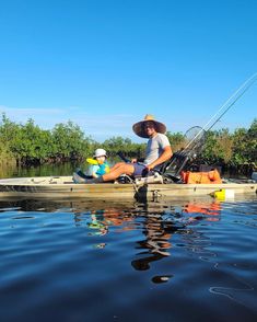 a man sitting on top of a boat in the water