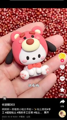 a person holding a small toy in their hand with the caption hello kitty on it