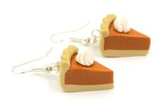 two slices of pie are shown on earrings