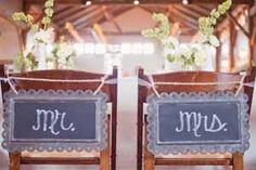 two wooden chairs with signs on them that say mr and mrs