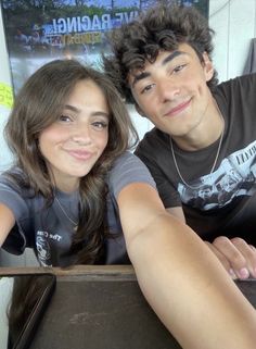 a young man and woman sitting next to each other