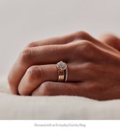 a woman's hand with a diamond ring on it