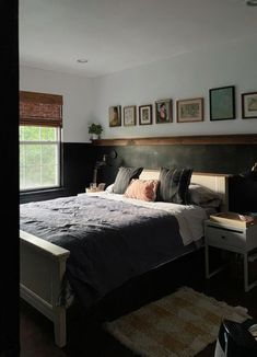 a bedroom with a bed, desk and pictures on the wall above it's headboard