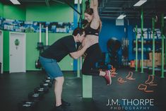 a man and woman doing exercises in a gym