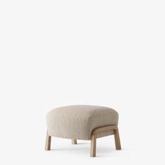 the foot stool is made out of wood and sheep wool