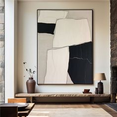 a living room with a large painting hanging on the wall next to a fire place