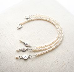 Bridesmaid Bracelet, Pearl Bracelet, Initial Bracelet, Personalized Jewelry, Bridesmaid Gift There are oodles of pearls on these bracelets. They make a lovely gift for your bridesmaids. One that they can wear well after your wedding day! + Small Freshwater Pearls (size of pearls are approx. 3mm) Sterling Silver Initial & Lobster Clasp. + Initial: Pick upon checkout. + Bracelet Length: Pick upon checkout. + Your jewelry will come in a jewelry box, tied with a ribbon, ready for gift giving. Th Elegant Adjustable Bridesmaid Bracelets, Elegant Personalized Adjustable Pearl Bracelet, Elegant Adjustable Personalized Pearl Bracelet, Adjustable Pearl Charm Bracelet For Wedding, Elegant Personalized Round Bead Pearl Bracelet, Personalized Round Bead Pearl Bracelet In Elegant Style, Elegant Personalized Pearl Bracelet, Personalized Elegant Pearl Bracelet, Personalized Round Bead Pearl Bracelet