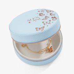 a small blue box with a butterfly charm on it's side and the lid open