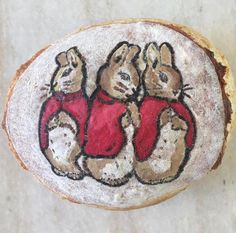 a piece of bread that has some animals on it and is decorated with red shirts