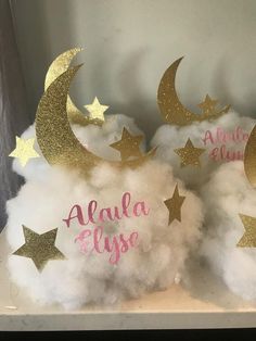 three clouds with gold stars and the words alula elye written on them