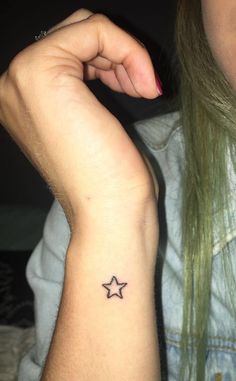 a woman with a small star tattoo on her arm