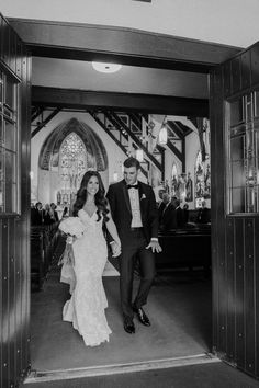 a bride and groom walking down the aisle